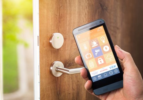 smart house, home automation, device with app icons. Man uses his smartphone with smarthome security app to unlock the door of his house.