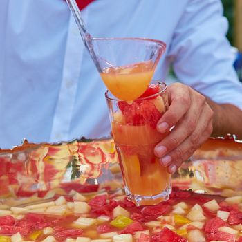 mixed punch with fresh fruits in metal bowl