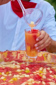 mixed punch with fresh fruits in metal bowl