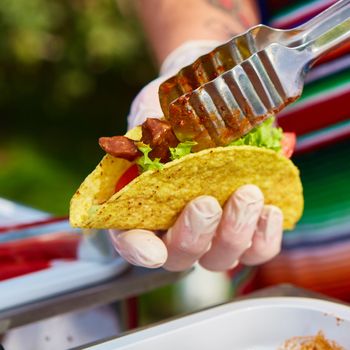 Chef making tacos at a street cafe. selective focus