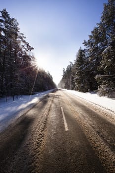 the road covered with snow in a winter season