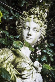 Old statue inside the Royal Palace garden in Caserta, Italy 