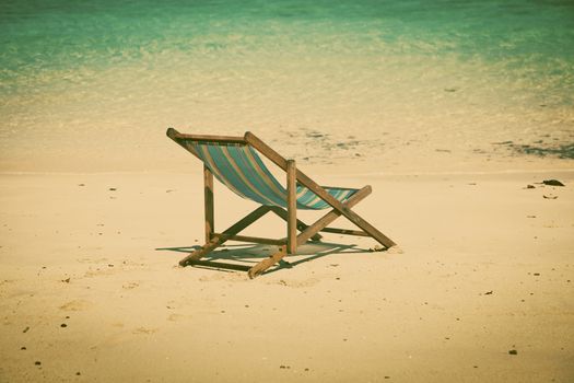 Exotic beach holiday background with white hate on beach chair