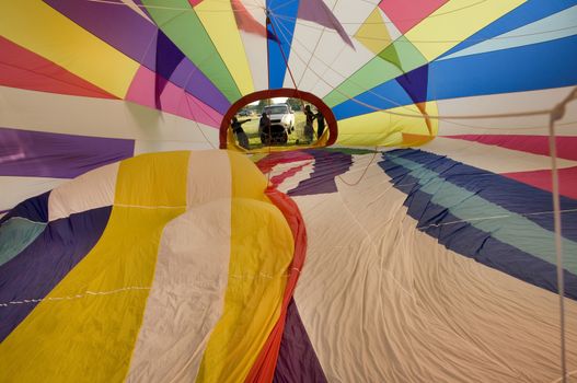 Interior of the envelope of a hot-air balloon during the cold inflation stage of prepping for launch, shot from upper vent.