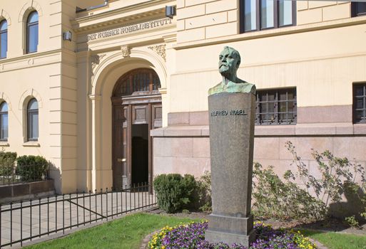 Entrance of The Norwegian Nobel Institute in Oslo with a bust of Alfred Nobel in the foreground.