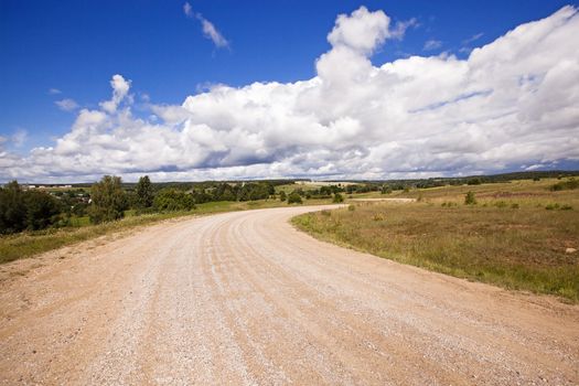  not asphalted rural road which is passing across the field