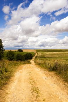   not asphalted rural road passing through hills