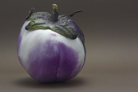 Ripe fresh eggplant isolated on brown background as a concept of healthy nutrition