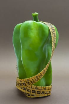 Green pepper isolated on a brown background to understand a concept to healthy eating