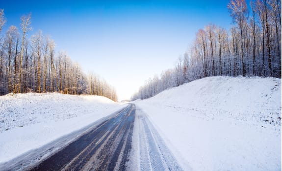 the road covered with snow in a winter season