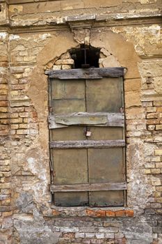  the window closed by boards which is on the ancient collapsing building.