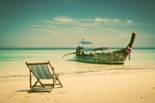 Exotic beach holiday background with beach chair and long tail boat - Thailand ocean landscape