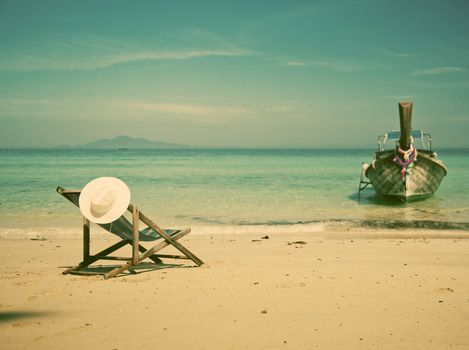 Exotic beach holiday background with beach chair and long tail boat - Thailand ocean landscape