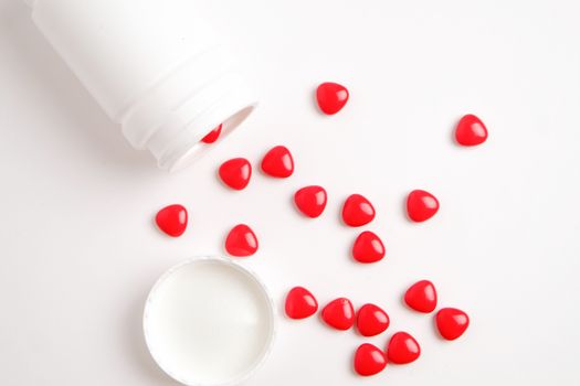 red vitamin (medicine) on white table