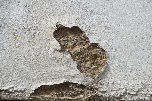 outside wall showing patch of damaged render