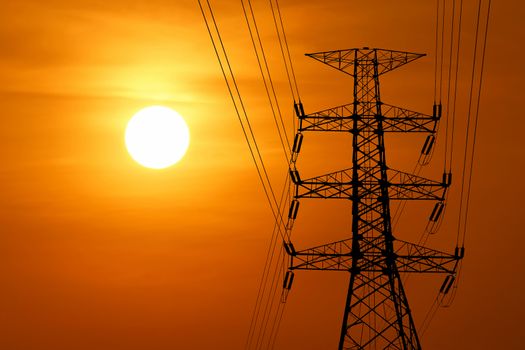 silhouette of high voltage electric tower with beautiful sunset  background