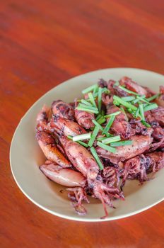plate of sauteed small squid fried with garlic and sauce