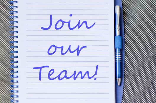Blue notepad and Join our team text concept