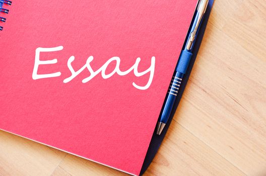 Notepad and pen on wooden background and text concept