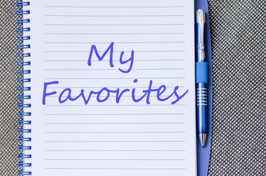 Notepad and pen on wooden background and text concept