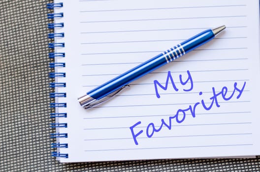 Notepad and pen on wooden background and text concept
