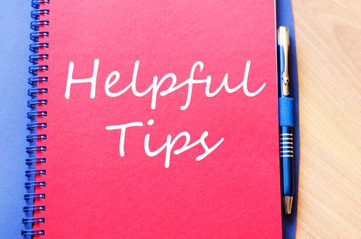 Red notepad and Helpful tips text concept