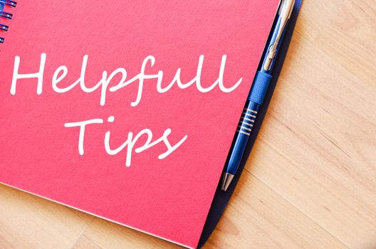 Red notepad and Helpful tips text concept