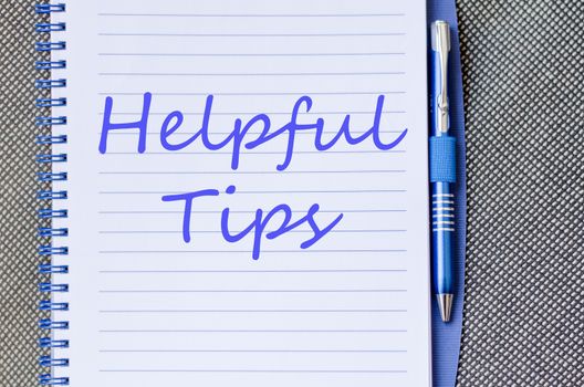 Blue notepad and Helpful tips text concept