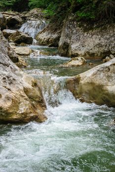 Waterfall in forest at mountains, Lacu Rosu national park, Romania