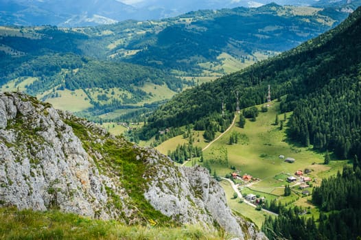 Bird view from Suhardul Mic mountain to populated valley in Red Lake AKA Lacu Rosu area, Carpathians Romania.