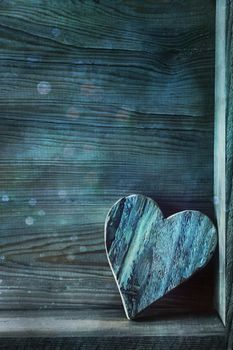 Blue wooden heart on wood background