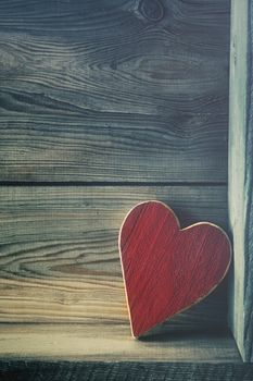 Red wooden heart on shelf