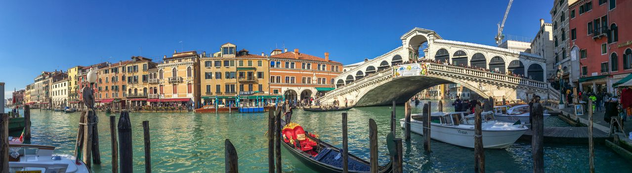 VENICE - FEBRUARY 8, 2015: Tourists along city canals. Venice attracts 20 million people annually.
