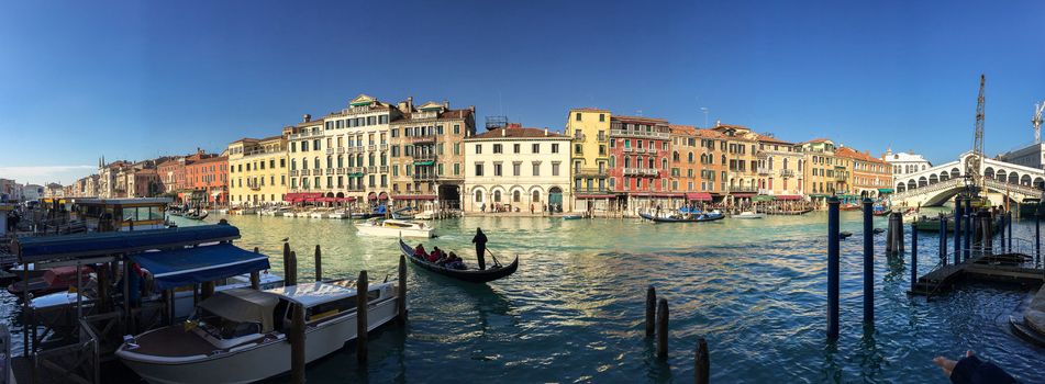 VENICE - FEBRUARY 8, 2015: Tourists along city canals. Venice attracts 20 million people annually.