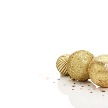 Gold Christmas balls with stars on white background. A lot of white copy space.