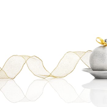 Silver Christmas ball with gold colored bow on white background.