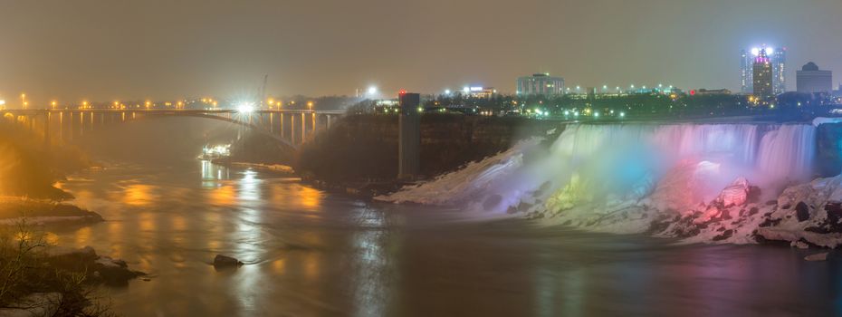 Panorama Illumination light of american Falls as viewed from Table Rock in Queen Victoria Park in Niagara Falls at night, Ontario, Canada 