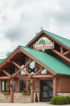 OWATONNA, MN/USA - AUGUST 9, 2015: Timberlodge Steakhouse exterior and sign. Timber Lodge Steakhouse is a private American steakhouse chain.