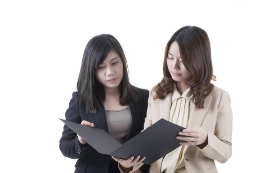 Two asian business woman in office, discussing profile