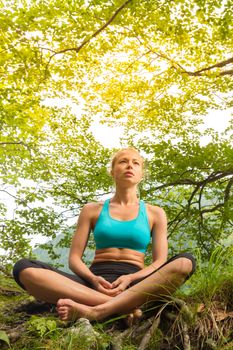 Relaxed woman enjoying freedom and life in beautiful natural environment. Blissful girl feeling relaxed, free and happy. Concept of freedom, happiness, enjoyment and natural balance.