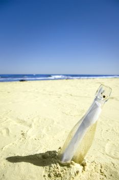 Message conceptual image. Message in a bottle on sand.