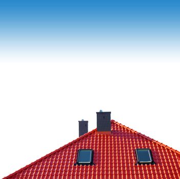 Red roof of new detached house against blue sky.