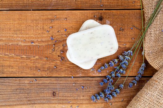 Bars of soap with lavender on a rustic wooden background