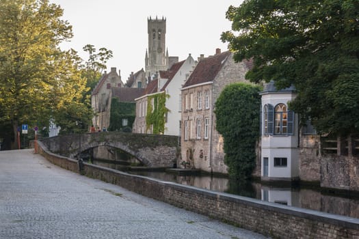 Canal in Bruges with a view on a Belfry

