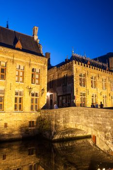 Night shot of historic medieval buildings along a canal in Bruges, Belgium