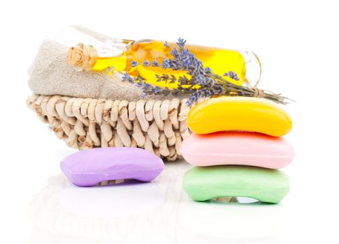 Spa still life with handmade soaps, lavender flowers and oil, on white background