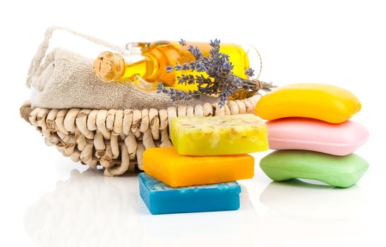 Spa still life with handmade soaps, lavender flowers and oil, on white background