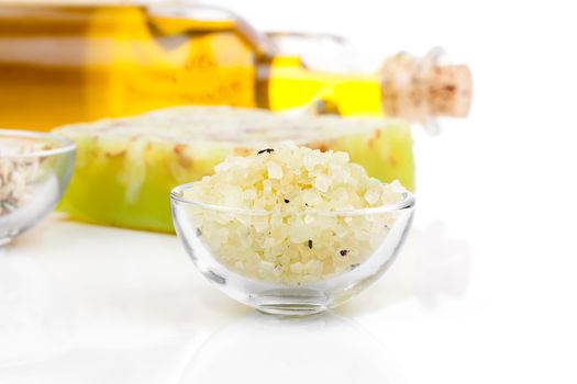 Spa still life with bath salt, soap and oil, on white background