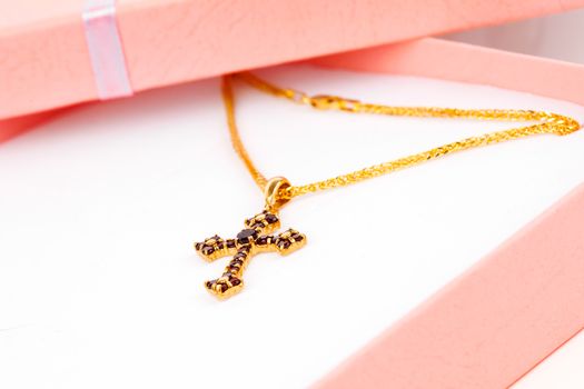 Golden Cross with garnets in packaged