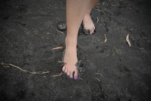 Human foot in wet soil